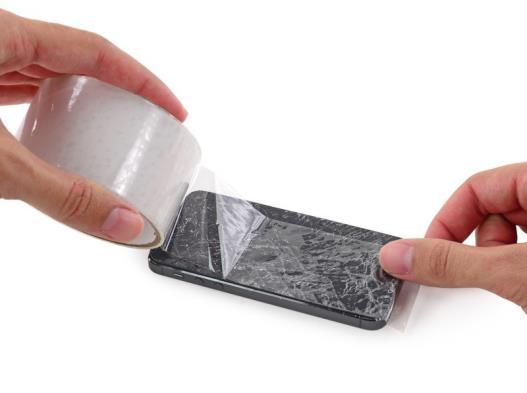 Lay overlapping strips of clear packing tape over the iphone's display until the whole face is