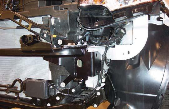 L bolt through the main receiver brace and into the bumper core mounting points (Fig.K driver's side). 10.