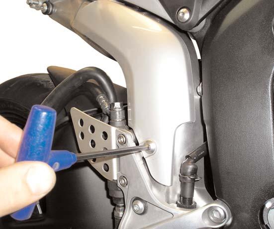 See Figure #9 14)Carefully pull the rider peg assembly away from the motorcycle frame.