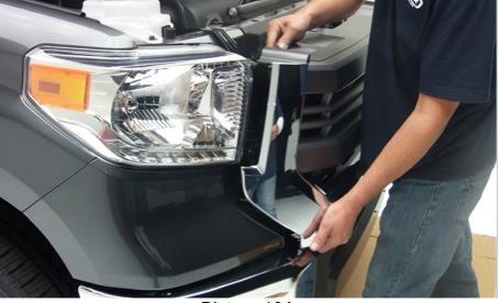 while pulling the bottom of the factory grille forward, remove the factory grille from the vehicle