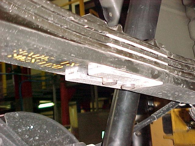 INSTALL THE SUPPLIED WEDGE ON TOP OF THE AXLE WITH THE THICKER END OF THE WEDGE TOWARD THE REAR OF THE VEHICLE. REFER TO PHOTO BELOW.
