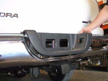 Remove two outer bumper fascias. b. Remove two screws and license plate from bumper. Outer Fascia c.