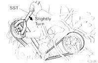 When replacing timing belt tensioner only: To avoid meshing of the timing pulley and timing belt, secure