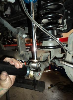 Install front coil springs on both driver and passenger sides, smaller pigtail end of spring should be at the frame side (top) with the factory coil spring rubber isolator retained at the top.