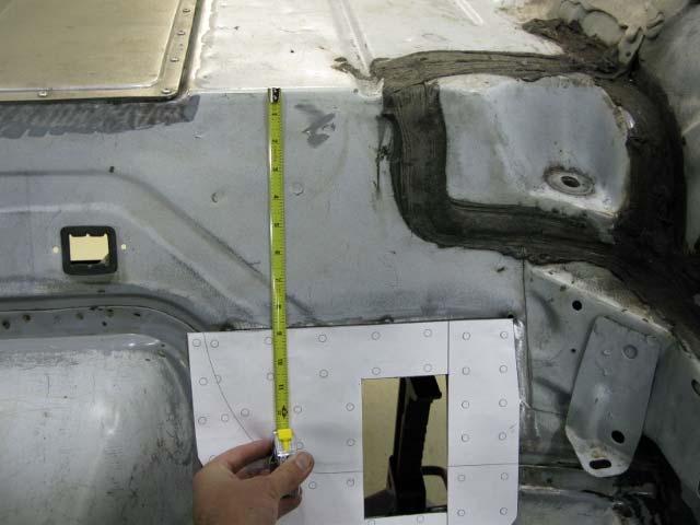 3. Cut out the provided floor cut template and position as shown below (Figure 1). The top flange of the template should be 8-5/8 from the edge of the trunk surface.