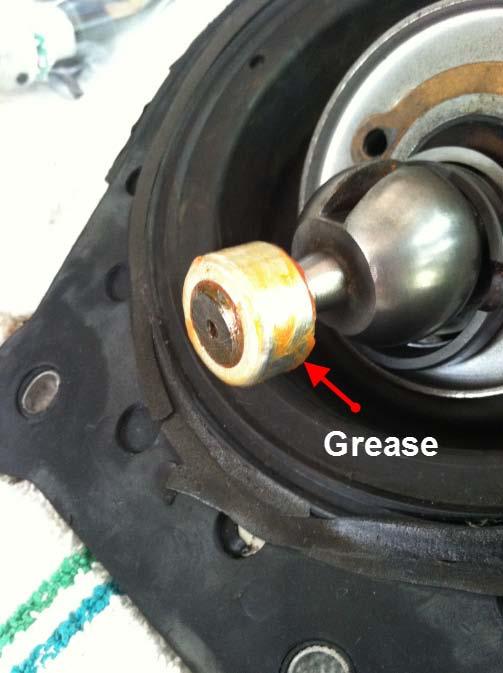 14. Take some more grease and coat the outside surface of the shifter bushing after it has been installed on the shifter ball tip 15.
