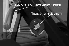 Raise handle adjustment lever and lock into the transport notch in an upright position. Tilt machine onto wheels and transport slowly.