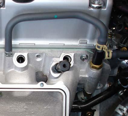 Move the harness to the engine side of the thermostat housing tab and secure it