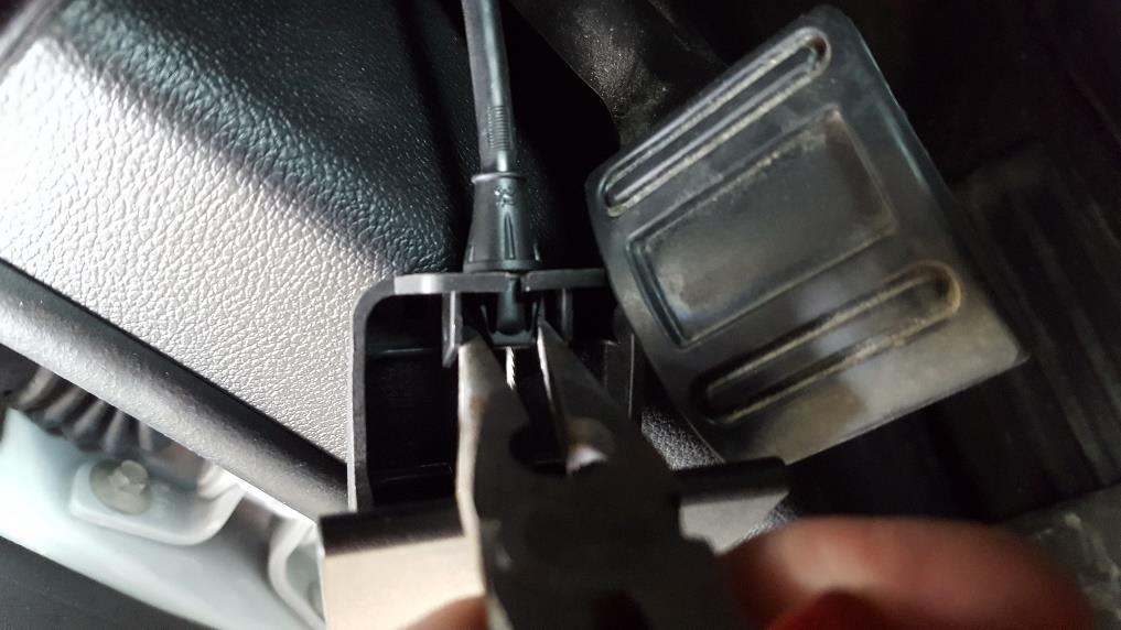Step 7: Remove the hood lever from cable using needle nose pliers, you need to squeeze the two tabs together for