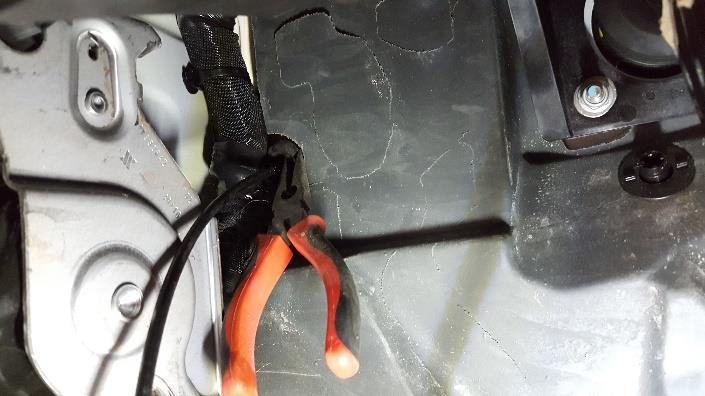 Step 8: Remove the cable from the firewall (the wall between the cab and the engine) using the needle nose pliers.