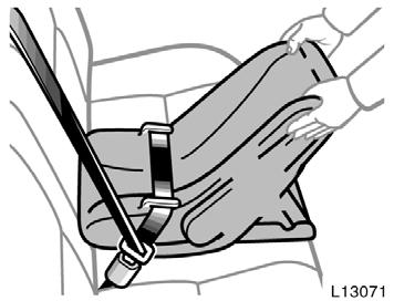 While pressing the infant seat firmly against the seat cushion and seatback, let the shoulder belt retract as far as it will go to hold the