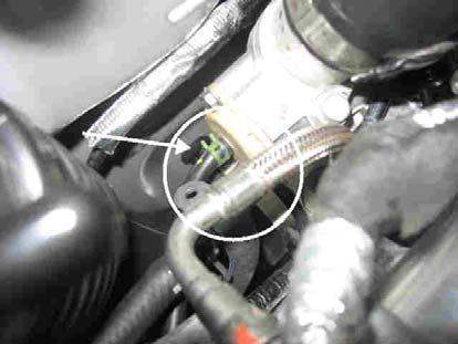 k) Using an 8mm nut driver and universal joint, remove the hose clamp holding compressor
