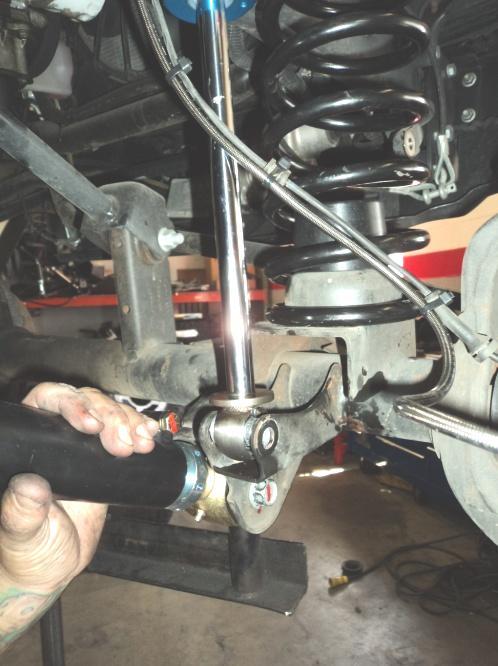 NOTES: Cutting and grinding is required to complete the installation of the rear roll center correction trackbar bracket.
