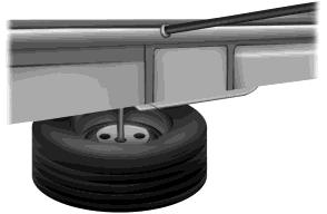 236 Wheels and Tires 5. Remove the jack handle from the right side compartment and insert the tip of the jack handle through the access hole and into the tube. 6.