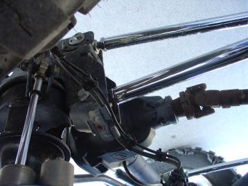 Locate the gusset brackets that fasten between the cross member mounting bolts (9/16 x 7 1/2 ) and the upper trailing arm bracket. (2.1 & 2.2) Step 9.