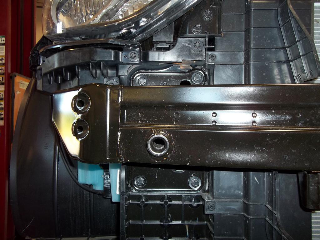 On each side, remove one 10mm (head) bolt attaching the horn to the bumper core (Fig.K).