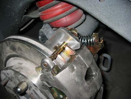 . Install and adjust the calipers Position the caliper in the bracket and install the caliper mounting pins.