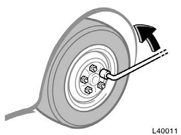 Loosening wheel nuts Positioning the jack Raising your vehicle 4. Loosen all the wheel nuts. Always loosen the wheel nuts before raising the vehicle. The nuts turn counterclockwise to loosen.