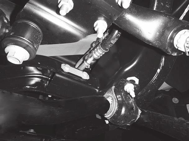 On trucks with hose assemblies in close proximity to the cross-beam bolt assembly, the nuts should be installed on the front side of the cross beam,