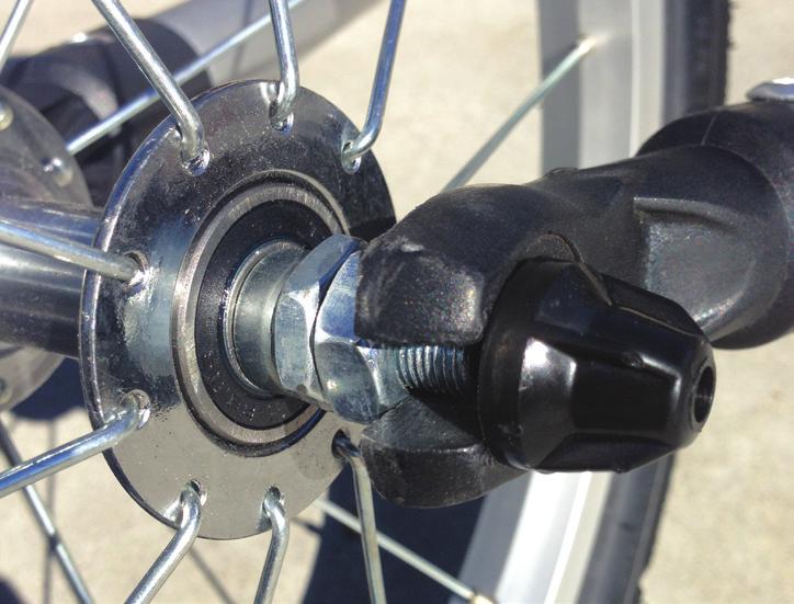 13 Next, install wheel as shown. Open the quick release axle skewer to allow the axle to fit inside the plastic fork tips.