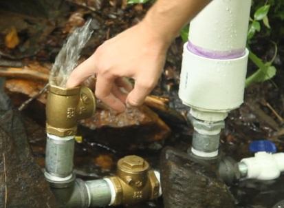 (This value might change depending on the flow and feet of head you have) Press the first check valve and hold it open to let water rush out of the valve.