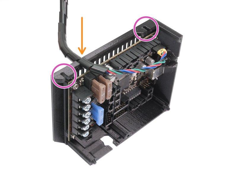 Push the spiral wrap in the slot and leave some slack of the cable along the board (don't stretch