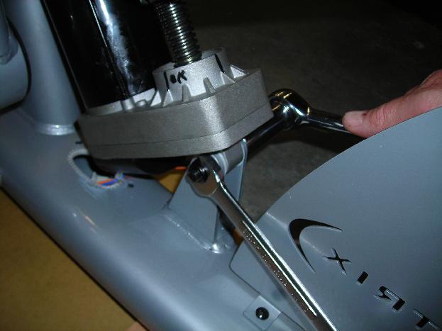 4) Carefully remove the two 8mm bolts that hold the swing arm to the motor assembly (Figure B).