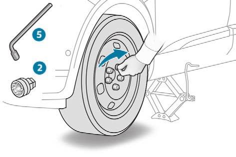 F Raise the vehicle until there is sufficient space between the wheel and the ground to admit the spare (not punctured) wheel easily.