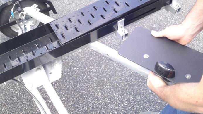 7. Place the removable cross bar under the track and loosely place the bolts in place.