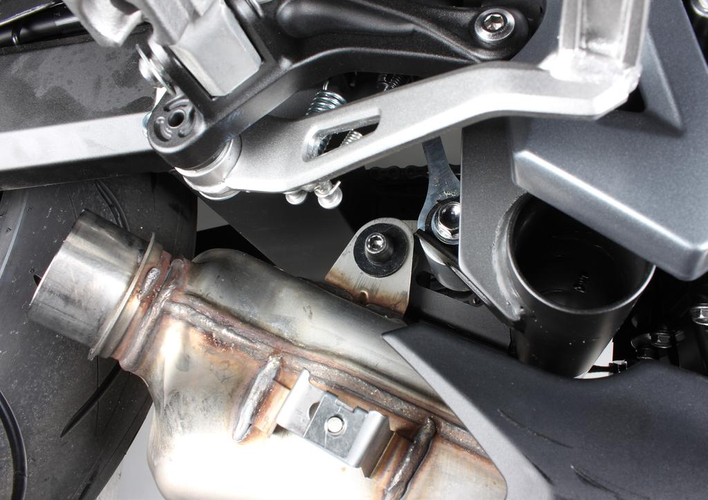5. Unscrew and remove the market bolt and carefully remove the stock exhaust off the motorcycle (F 03).
