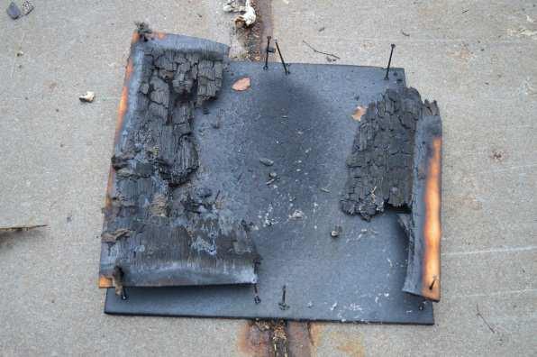 exposure of the backing board (flames in the cavity behind the covering), but probably only for