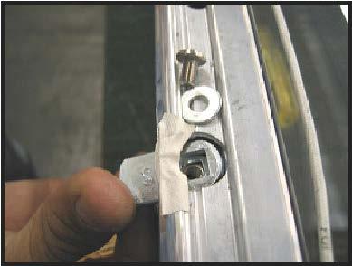 3. Insert a large phillips-head screwdriver into the lock access in the back of the door rail.