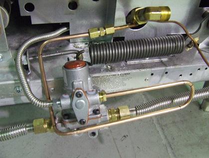 If a fitting was already installed on the pilot gas tube, unscrew one end of the unused 3/16 fitting to release the nut and ferrule Unscrew the nut on the Baso valve pilot gas inlet to release the