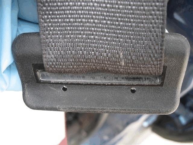 The safety belt webbing exhibited evidence of occupant loading on both sides of the webbing. On the back side, an abrasion that measured 5 x 10 cm (2.0 x 3.9 in) was located 155 cm (61.