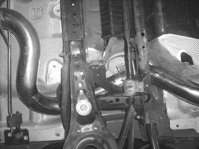 4. Insert the handle bar hangers on the ROUSH Over-Axle Pipe (1213-5C262) into the factory rubber isolators near the rear of the vehicle.