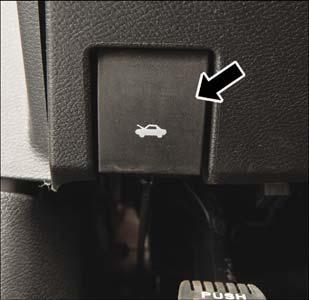 Hood Release 2. Move to the front of the vehicle. 3. Reach under the center front edge of the hood and push and hold the safety catch lever to the left. 4. Lift the hood upward to the open position.