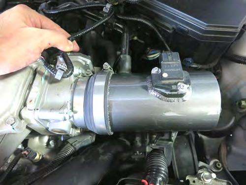 Using the step coupler and provided hose clamps, install the intake