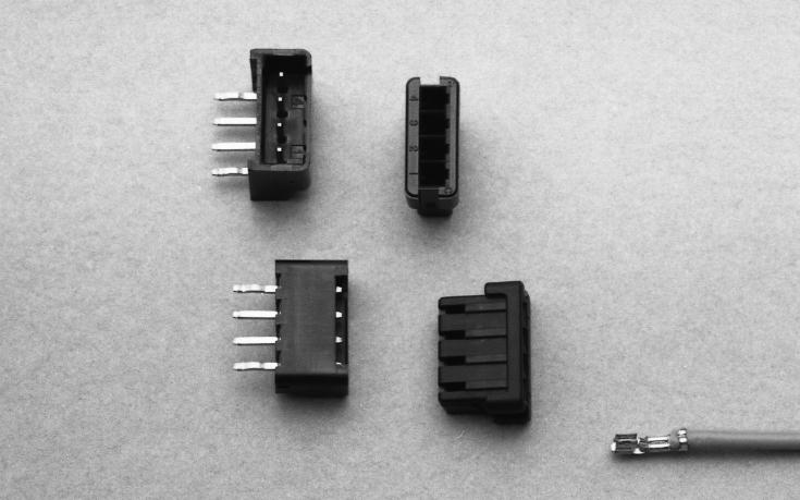 spacings mounted to printed circuit board to be mated with a series of housings in which receptacles crimped with wire leads are mounted for external connections.