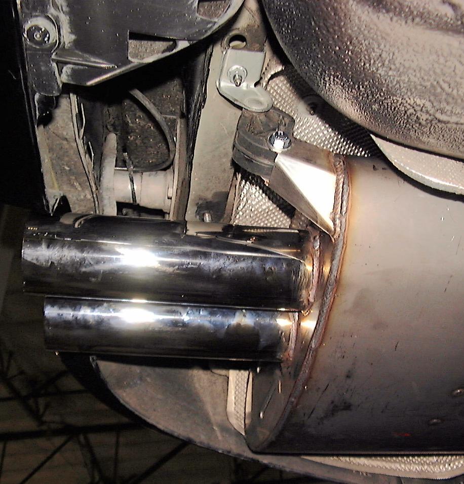 When the exhaust gets hot it grows in length and the hangers will hang straight. Note angle of rubber hangers: Lower bolts are forward of upper pins.