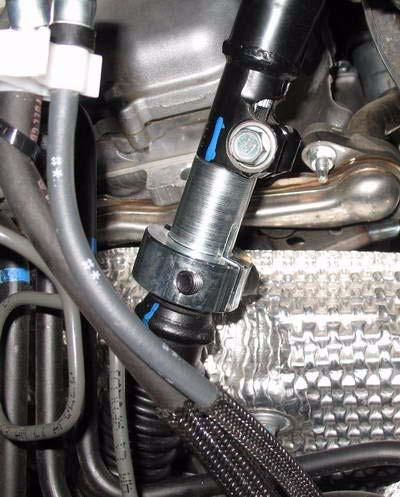 Clip positive battery cable, starting from passenger side, in two clips along bottom of engine.