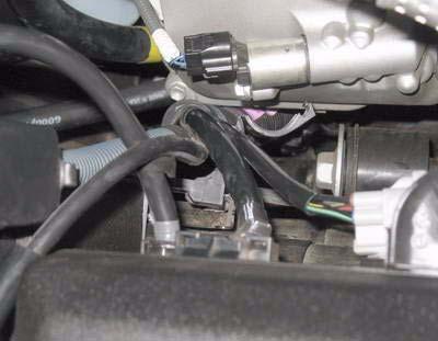 amps. c. Remove positive battery cable from two clips along bottom front of engine.