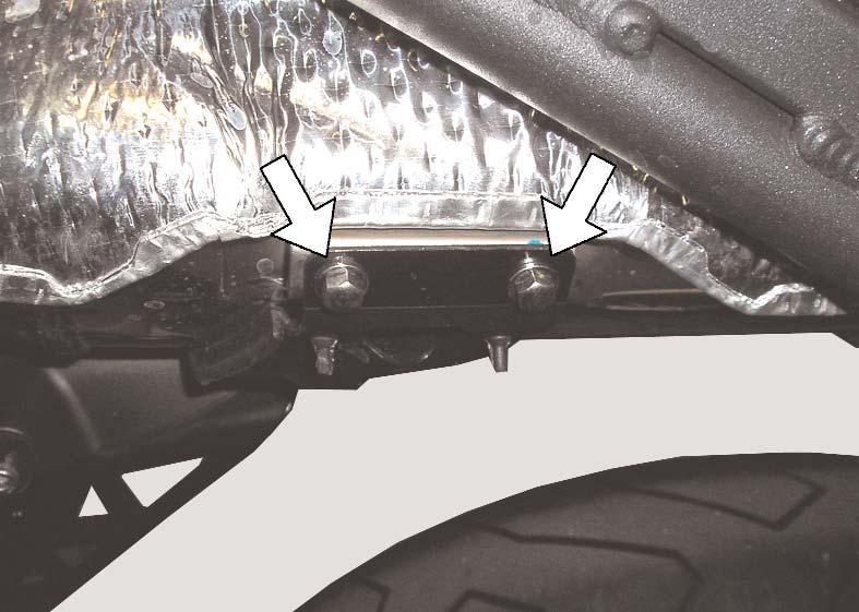 14)Have your helper carefully raise the gas tank, and hold it out of the way of the subframe mounting bolts. 15)Remove the four subframe mounting bolts.