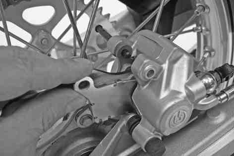 Operate the foot brake lever repeatedly until the brake linings are in contact with the brake disc and there is a pressure point.