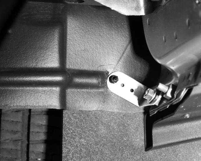 Align free end of stabilizing bracket with wheel well and mud flap. Attach stabilizing bracket to exposed threads H.