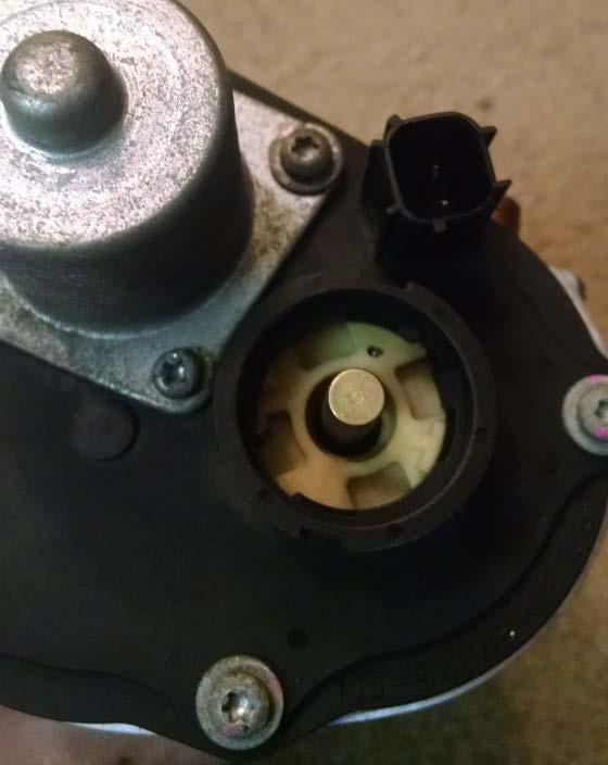 10. Install the motor housing, without the black circular cap, onto the throttle body