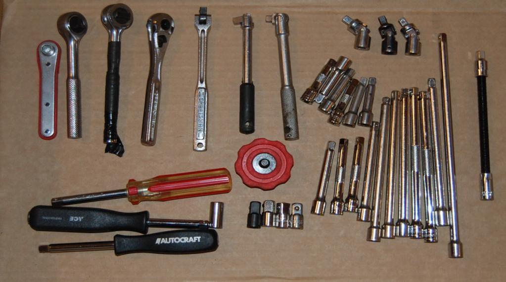 Top left: A 1/4 screwdriver bit ratchet, two cheap ratchets, a Craftsman ratchet, a Craftsman breaker bar, two cheap breaker bars.