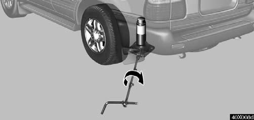 IN CASE OF AN EMERGENCY 40X008d 40X009a 6. After making sure no one is in the vehicle, raise it high enough so that the spare tire can be installed.