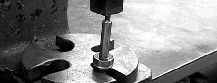 If bearing is binding against the retaining ring so that it cannot easily be removed, place the motor body (threaded portion of the shaft up) on arbor press.