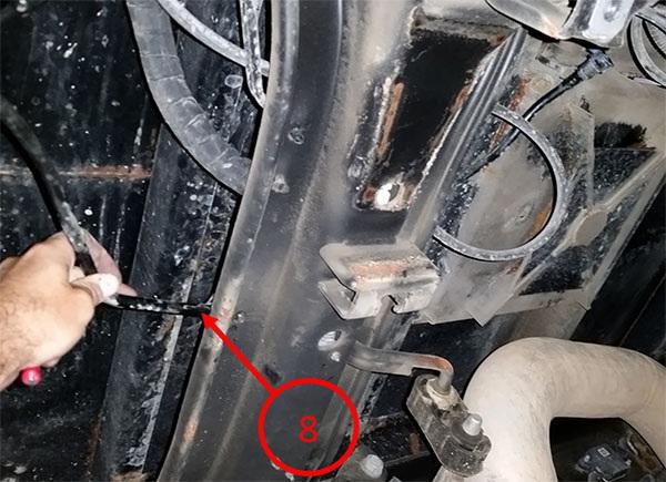 8. Remove plastic clip (9) seen below from fuel balance pump line and place clip back into hole in