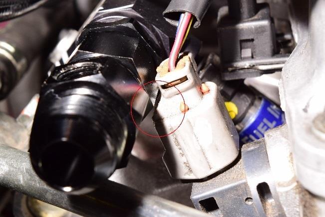 This can be done by using small cutters and trimming the connector in the area circled. This trimming does not impact the locking function of the connector. 18.